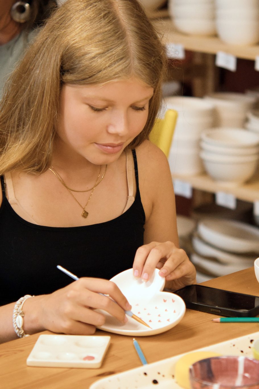 Mädchen beim Keramik bemalen 